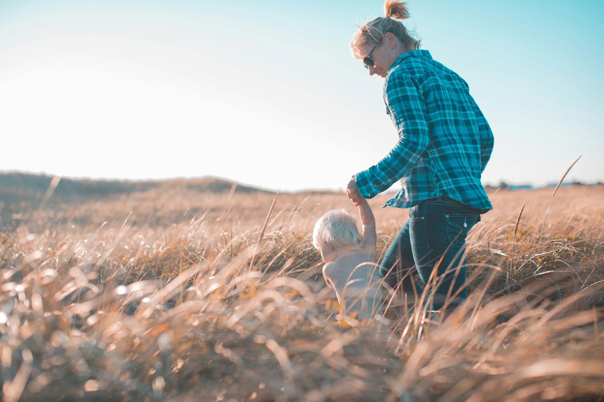 woman-child-field woman and child hike enjoy healthy lifestyle and hike through field